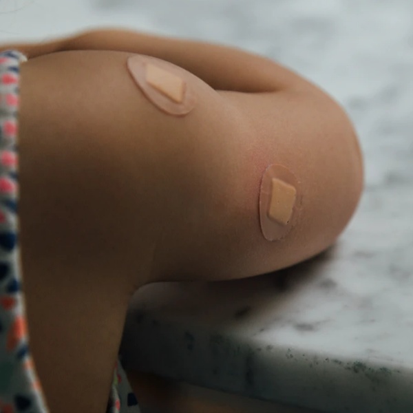 A child with a bandage on their shoulder